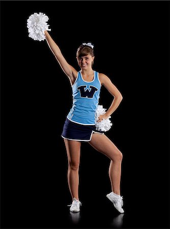 Studio shot of cheerleader (16-17) striking pose Foto de stock - Royalty Free Premium, Número: 640-06963671
