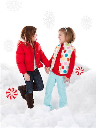 Studio shot of girls (4-5, 6-7) standing in snow Stock Photo - Premium Royalty-Free, Code: 640-06963716