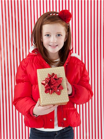 striped wrapping paper - Studio portrait of girl (4-5) holding of Christmas gift Stock Photo - Premium Royalty-Free, Code: 640-06963712
