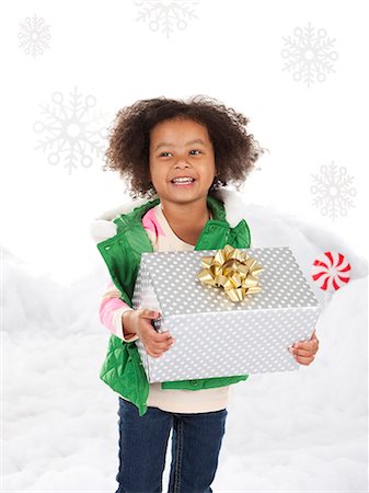 pictures of african american people in the snow - Girl (4-5) holding christmas gift Stock Photo - Premium Royalty-Free, Code: 640-06963741