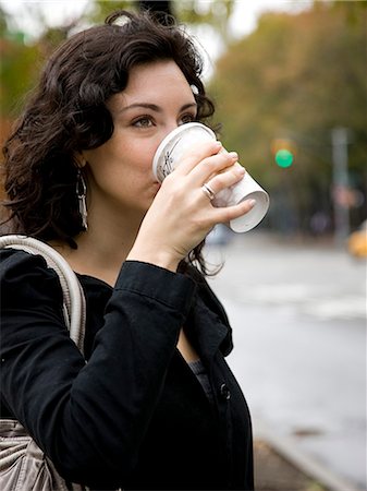 USA, New York, Manhattan, Greenwich Village, Young woman drinking coffee outdoors Stock Photo - Premium Royalty-Free, Code: 640-08088971