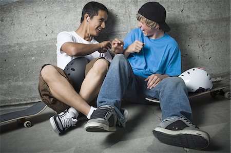 portrait of boy sitting on skateboard - Portrait of two teenage boys smiling Stock Photo - Premium Royalty-Free, Code: 640-08089057