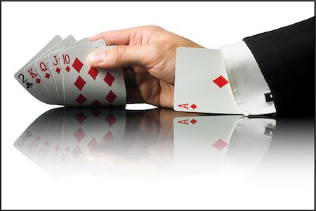 hand holding playing cards with an ace up his sleeve Stock Photo - Premium Royalty-Free, Code: 640-08089159