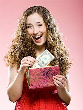 simsearch:640-08089417,k - woman putting money in her purse Stock Photo - Premium Royalty-Free, Code: 640-08089232