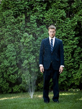 simsearch:640-08089629,k - man in a suit standing next to a sprinkler Stock Photo - Premium Royalty-Free, Code: 640-08089438
