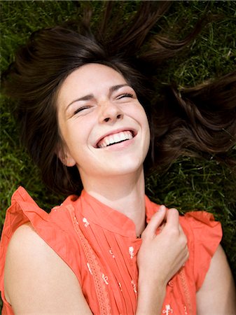 simsearch:640-08089565,k - woman lying on the grass laughing Stock Photo - Premium Royalty-Free, Code: 640-08089472