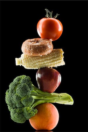 piled high - pile of fruit and vegetables with a donut in between Stock Photo - Premium Royalty-Free, Code: 640-08089591