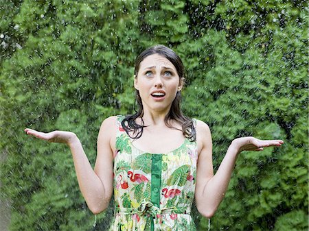 woman in a dress standing in the sprinklers Stock Photo - Premium Royalty-Free, Code: 640-08089613