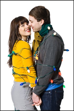 couple wrapped together with christmas lights Stock Photo - Premium Royalty-Free, Code: 640-08089715