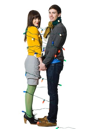 couple wrapped together with christmas lights Stock Photo - Premium Royalty-Free, Code: 640-08089716