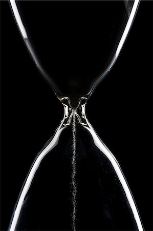 past time - Studio shot of hourglass on black background Stock Photo - Premium Royalty-Free, Code: 640-08089778