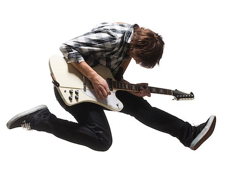 simsearch:640-06050812,k - Studio shot of young man (18-19) jumping in air while playing guitar Fotografie stock - Premium Royalty-Free, Codice: 640-08089779