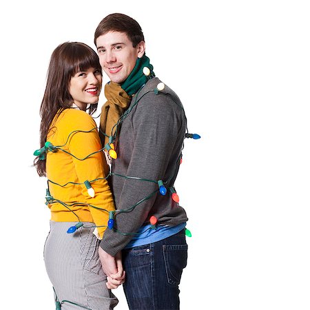 simsearch:640-08089533,k - Studio shot of young couple wrapped in Christmas lights Stock Photo - Premium Royalty-Free, Code: 640-08089785