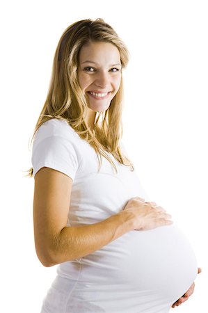 Studio shot of a pregnant young woman holding her belly Stock Photo - Premium Royalty-Free, Code: 640-08089780