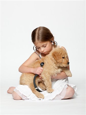 simsearch:640-06050836,k - Studio shot of girl (6-7) examining puppy with stethoscope Stock Photo - Premium Royalty-Free, Code: 640-08546107