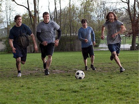 USA, Utah, Provo, Four friends playing football Stock Photo - Premium Royalty-Free, Code: 640-08546132