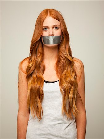 simsearch:640-08546148,k - Studio shot of young woman gagged with silver tape Stockbilder - Premium RF Lizenzfrei, Bildnummer: 640-08546150