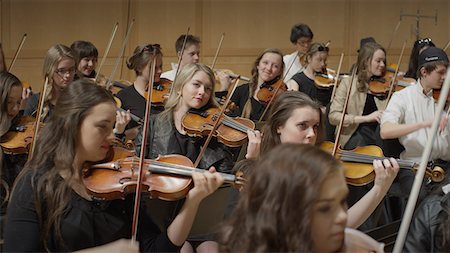 Selective focus view of student musicians playing instruments in orchestra recital Stock Photo - Premium Royalty-Free, Code: 640-09013306