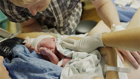 High angle view of new mother and father admiring newborn baby in hospital Stock Photo - Premium Royalty-Free, Code: 640-09013335