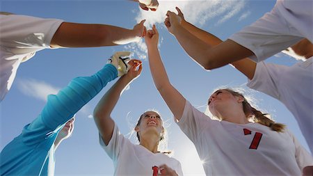 sports huddle - Low angle view of soccer team players cheering in huddle before game under clear blue sky Photographie de stock - Premium Libres de Droits, Code: 640-09013408