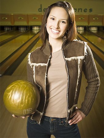 simsearch:640-03265586,k - Portrait of a teenage girl holding a bowling ball and smiling Stock Photo - Premium Royalty-Free, Code: 640-01348354