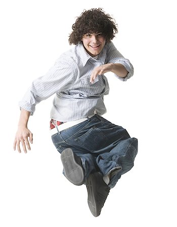 sole of shoe - Portrait of a teenage boy jumping in mid-air Foto de stock - Sin royalties Premium, Código: 640-01348363