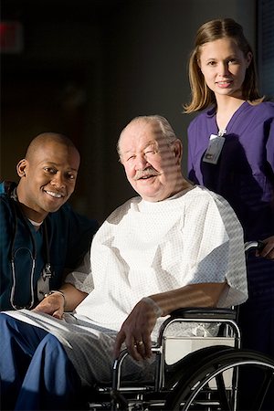 Portrait of a male doctor and a female nurse with a patient Stock Photo - Premium Royalty-Free, Code: 640-01348398