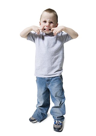 small cloth - Portrait of a boy sticking out his tongue Stock Photo - Premium Royalty-Free, Code: 640-01348403