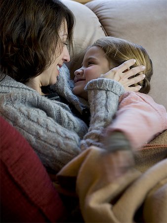 simsearch:640-01601434,k - Woman with young girl snuggling on sofa Stock Photo - Premium Royalty-Free, Code: 640-01348447