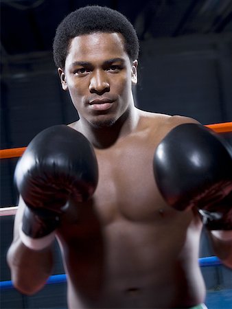 punching black people - Portrait of a young man boxing Stock Photo - Premium Royalty-Free, Code: 640-01348489