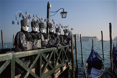 Portrait of group of people standing on a pier in masquerade costumes Stock Photo - Premium Royalty-Free, Code: 640-01348501