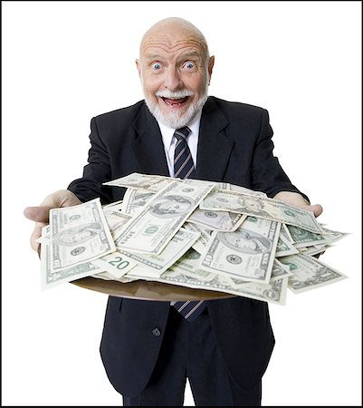 Close-up of a businessman holding American dollar bills in a plate Stock Photo - Premium Royalty-Free, Code: 640-01348532