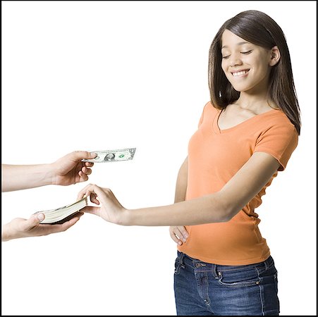 Girl taking a bundle of paper currency from a person Foto de stock - Sin royalties Premium, Código: 640-01348533