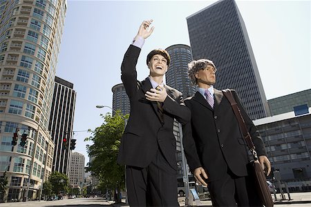 Low angle view of two mannequins portraying businessmen Stock Photo - Premium Royalty-Free, Code: 640-01348568