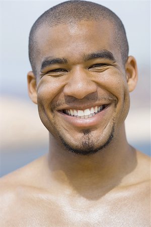 Close-up of a young man smiling Stock Photo - Premium Royalty-Free, Code: 640-01348619