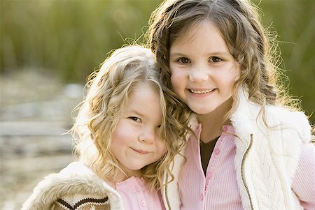 sister hugs baby - Portrait of two girls smiling and hugging outdoors Stock Photo - Premium Royalty-Free, Code: 640-01348632