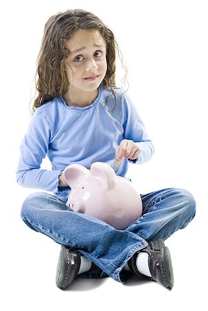 Portrait of a girl putting a coin in a piggy bank Foto de stock - Royalty Free Premium, Número: 640-01348645