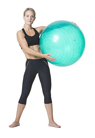 simsearch:640-01353414,k - Portrait of a young woman holding a fitness ball Stock Photo - Premium Royalty-Free, Code: 640-01348665