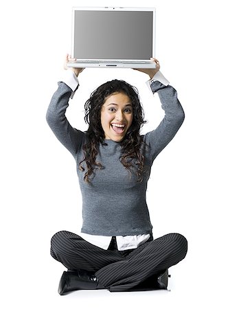 simsearch:640-01358649,k - Woman sitting cross legged with laptop smiling Fotografie stock - Premium Royalty-Free, Codice: 640-01348697
