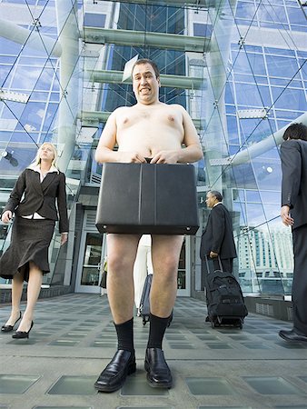 funny businesswoman shoes - Low angle view of a naked man holding a briefcase Stock Photo - Premium Royalty-Free, Code: 640-01348707