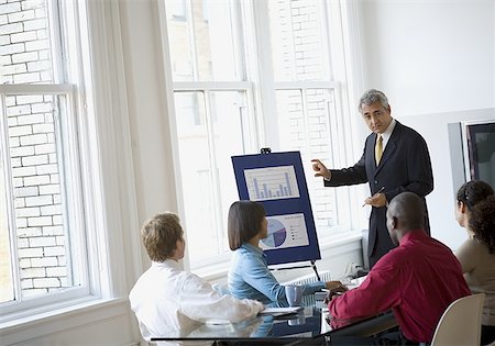 Three businessmen and two businesswomen in a meeting Stock Photo - Premium Royalty-Free, Code: 640-01348701