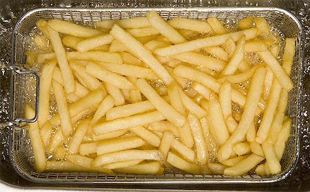 deep fry - Close-up of French fries cooking Stock Photo - Premium Royalty-Free, Code: 640-01348756