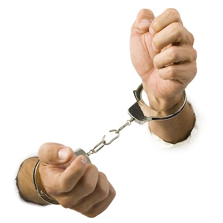Close-up of hands trying to break out of handcuffs Fotografie stock - Premium Royalty-Free, Codice: 640-01348750