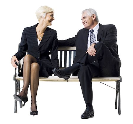 Businessman and businesswoman sitting on a bench Stock Photo - Premium Royalty-Free, Code: 640-01348772