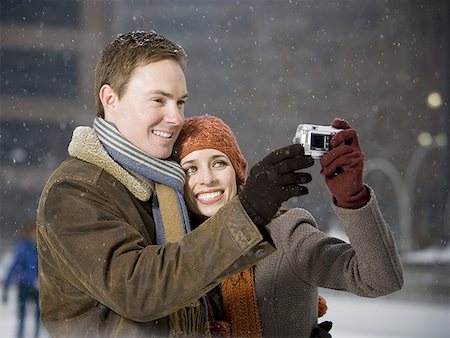 simsearch:640-02772458,k - Man and woman taking a photo outdoors in winter Stock Photo - Premium Royalty-Free, Code: 640-01348801