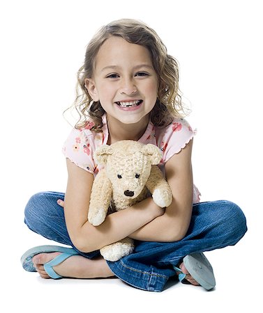 simsearch:640-03256263,k - Portrait d'une jeune fille embrassant un ours en peluche Photographie de stock - Premium Libres de Droits, Code: 640-01348827