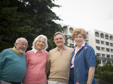 Portrait of two senior couples smiling together with their arms around each other Stock Photo - Premium Royalty-Free, Code: 640-01348878