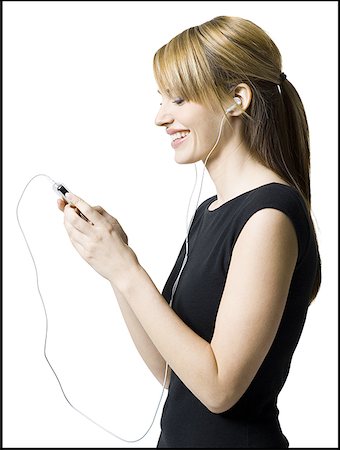 Profile of a young woman listening to an MP3 player Stock Photo - Premium Royalty-Free, Code: 640-01348882