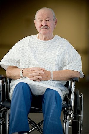 rushing patient - Male patient sitting in a wheelchair with his hands clasped Stock Photo - Premium Royalty-Free, Code: 640-01348899