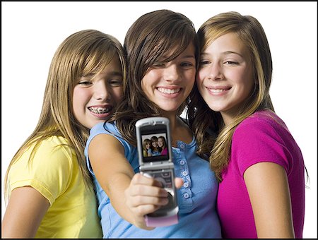 friends race - Three girls with camera phone Stock Photo - Premium Royalty-Free, Code: 640-01349020